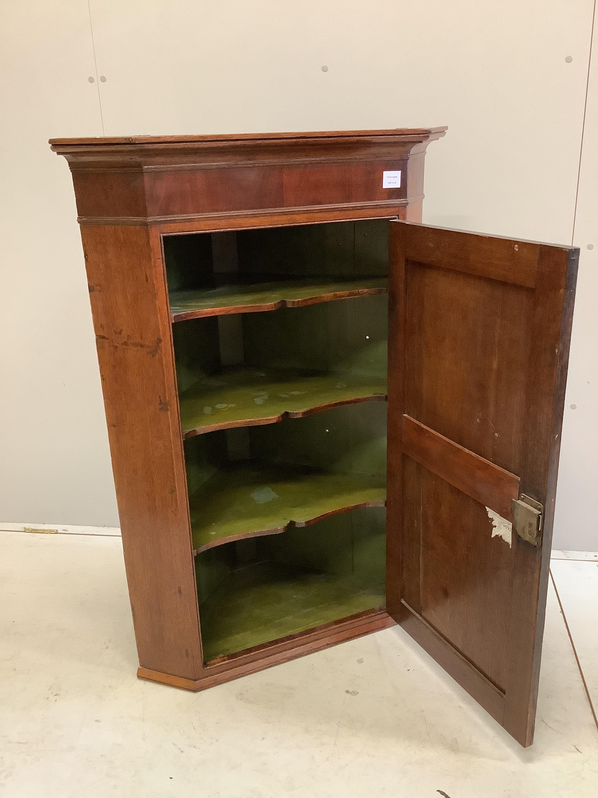 An early 19th century mahogany banded oak hanging corner cupboard, width 81cm, depth 48cm, height 119cm